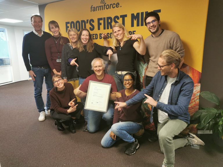 Group photo of the Farmforce team holding their framed ISO certificate.